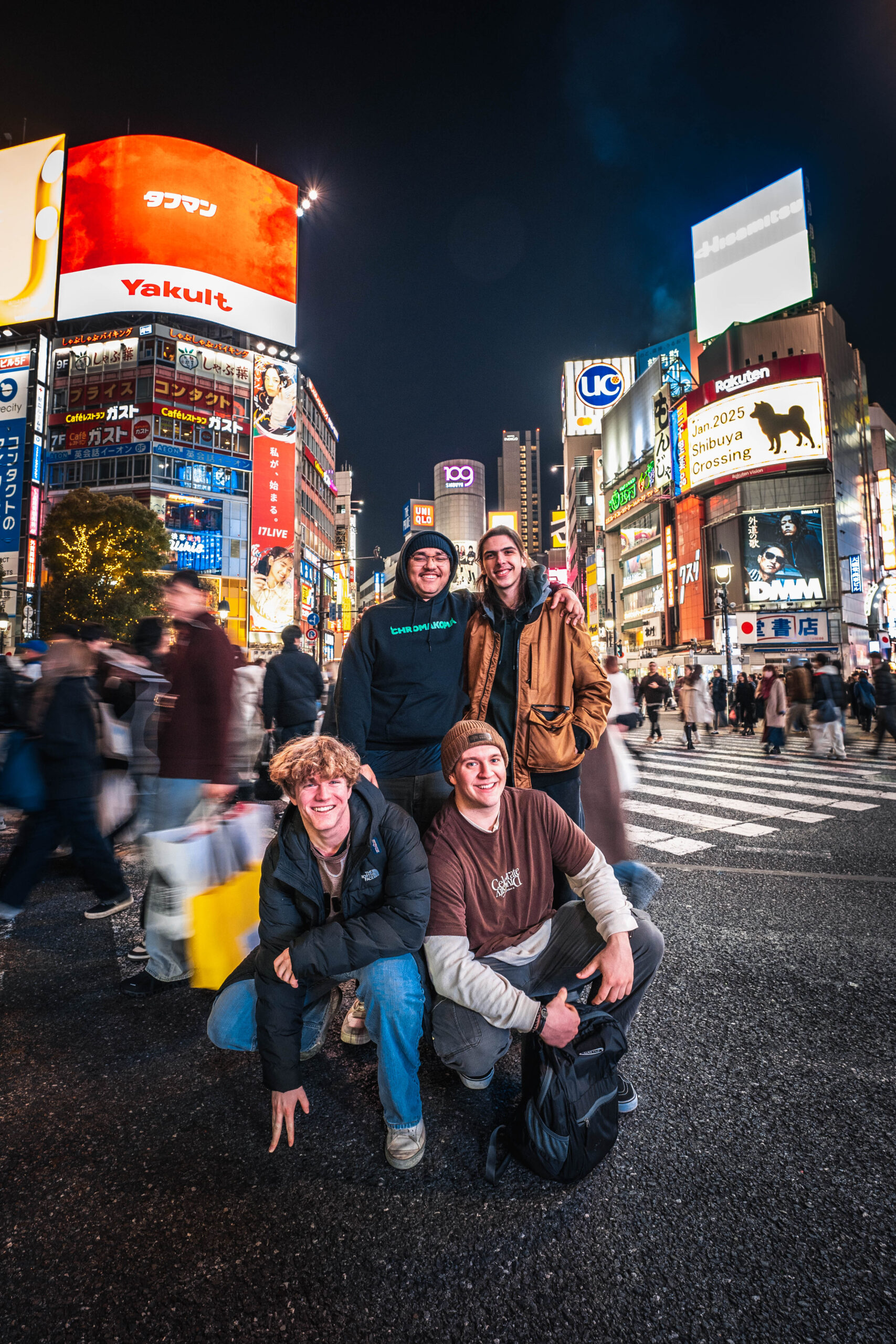 group of four friends photoshoot at Shibuya Crossing Tokyo at night