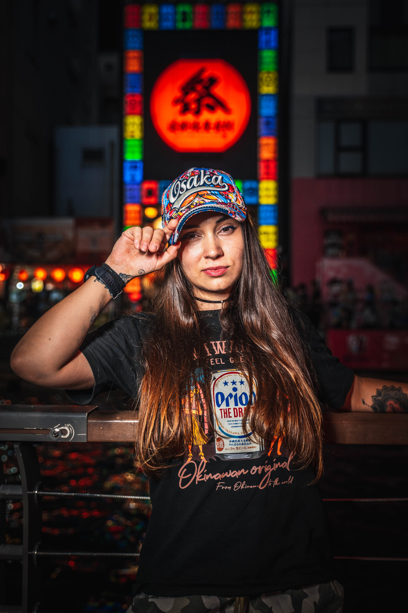 solo traveler portrait in Osaka at night with neon lights