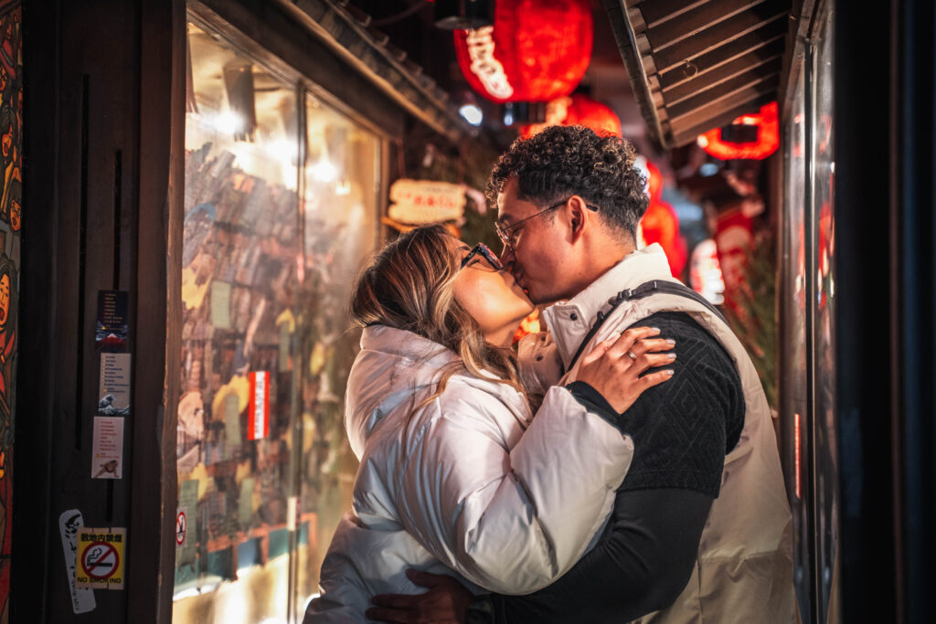 couple kissing in Osaka Dotonbori alley with lantern lights