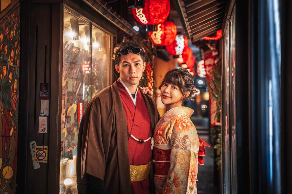 couple in kimono on a lantern-lit street in Osaka at night