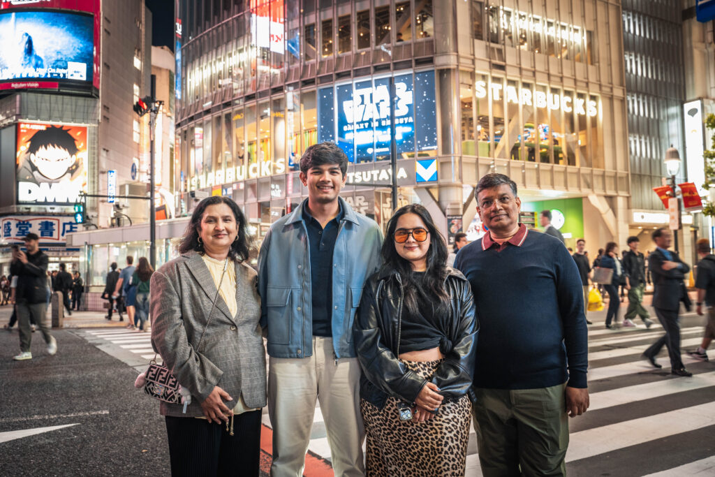family of four standing together at Shibuya Crossing Tokyo