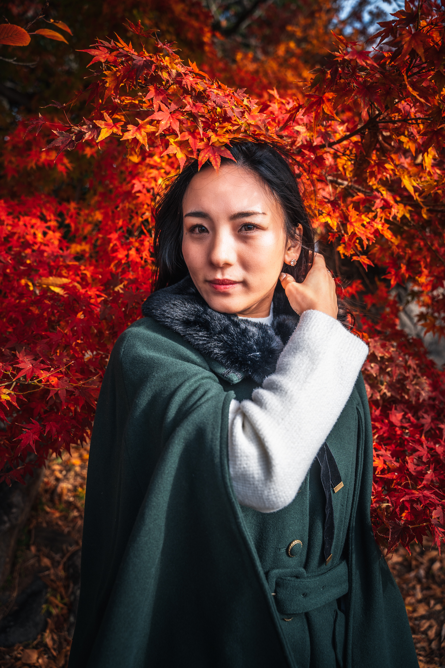 female portrait in Kyoto surrounded by autumn leaves
