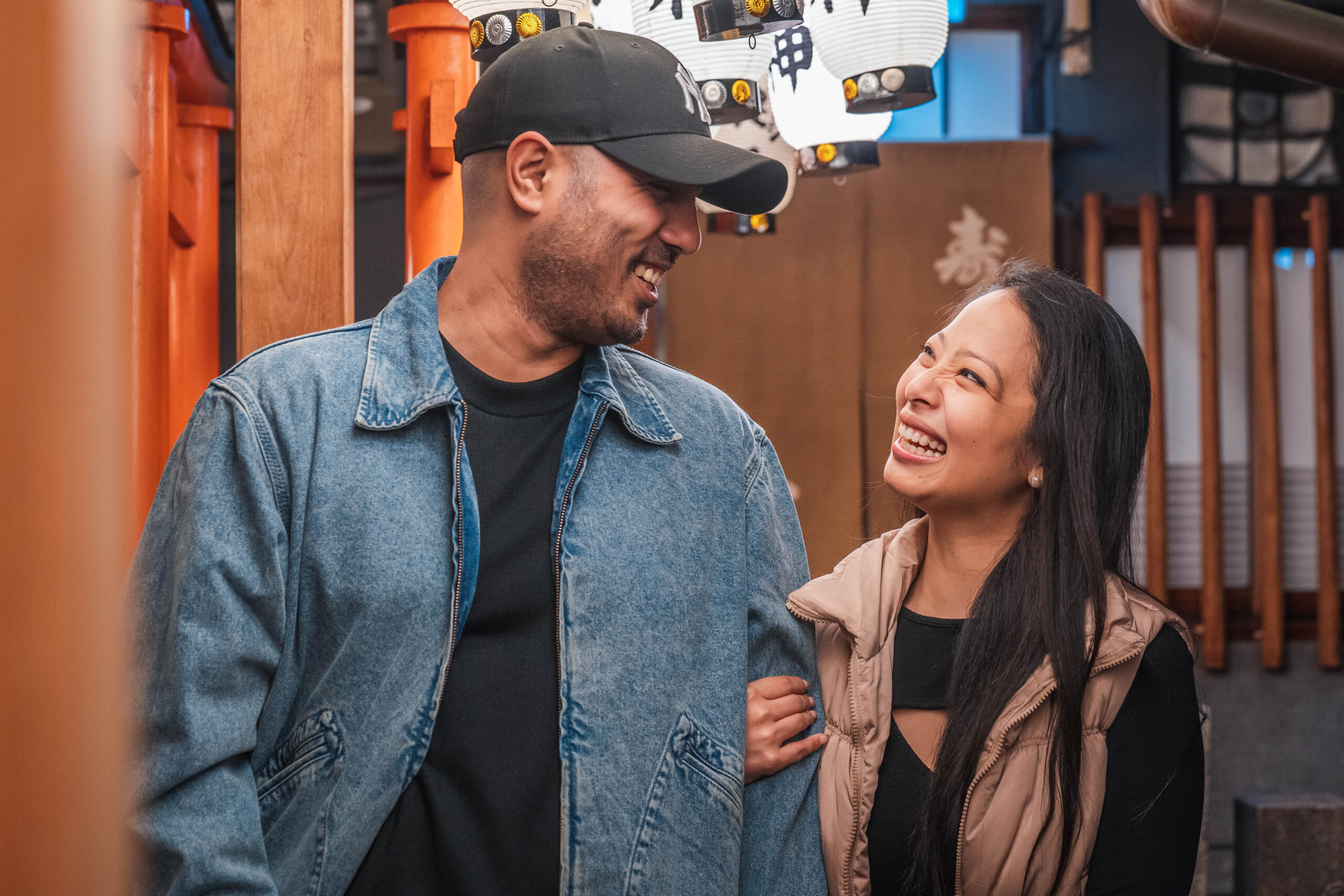 smiling couple looking at each other at a temple in Osaka at night