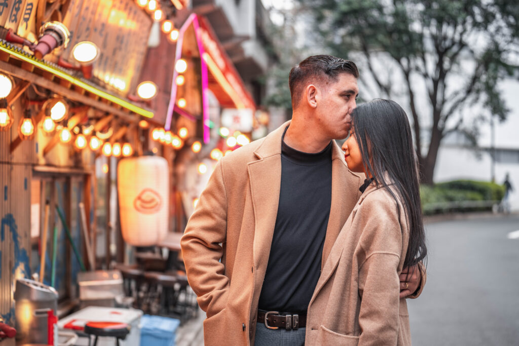 couple kissing on the forehead in Tokyo street