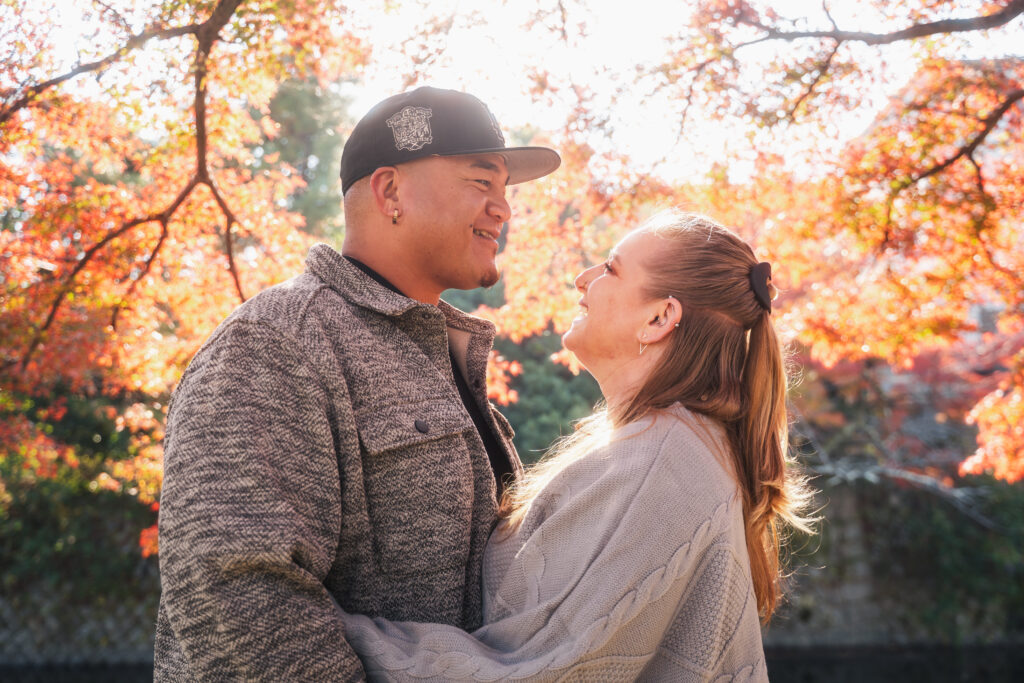 couple photoshoot surrounded by autumn leaves in Kyoto