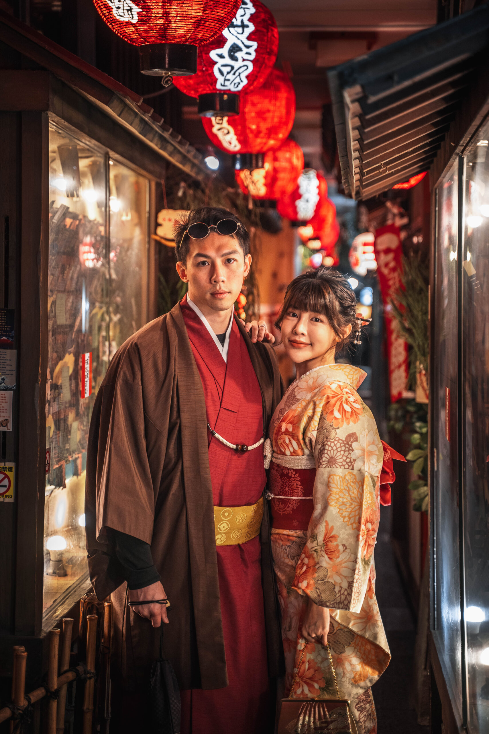 couple in kimono in a lantern-lit alley in Osaka at night