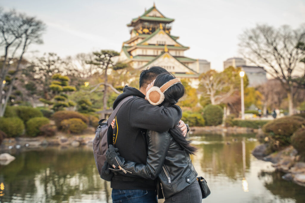 couple hugging in front of Osaka Castle