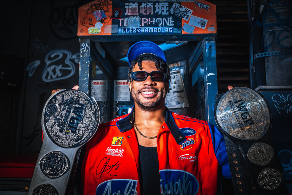 male portrait holding a championship belt in Osaka at night