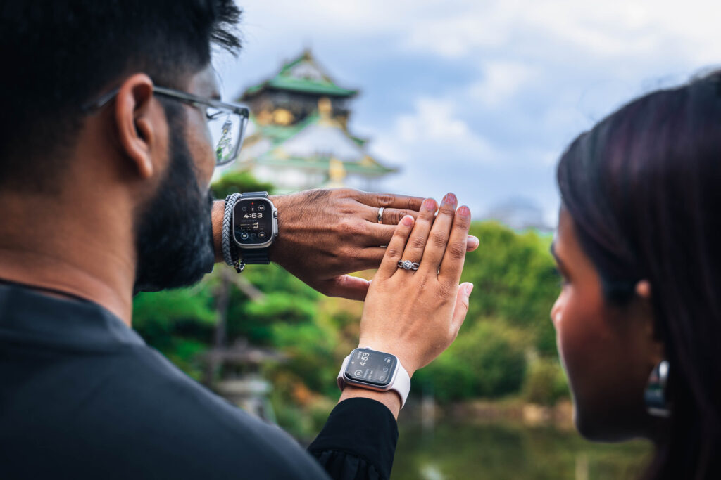 couple showing rings with arms together at Osaka Castle